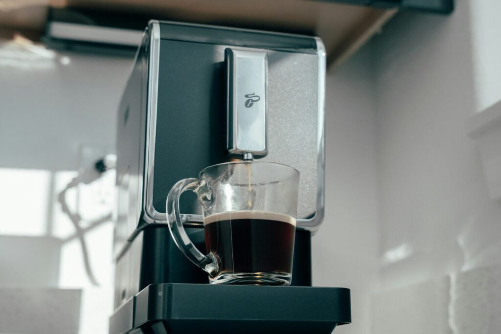 a cup of coffee sitting on top of a coffee maker